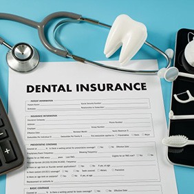 Dental insurance form surrounding by dental and medical instruments