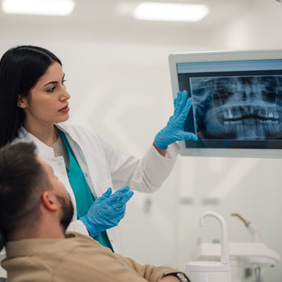Dentist and patient discussing X-ray