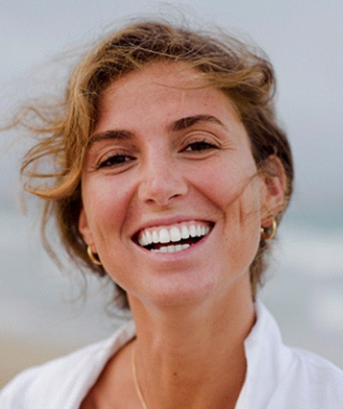 Woman with beautiful teeth standing on beach