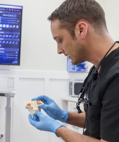 Dental lab technician crafting dental implant supported restoration