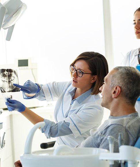 Dentist in Vero Beach talking to patient about tooth extractions