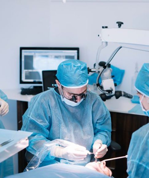 Dental team carefully performing surgery