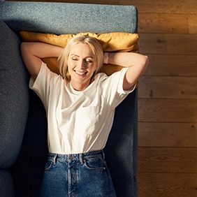 Woman relaxing at home on her sofa