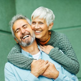 Mature couple smiling while embracing each other