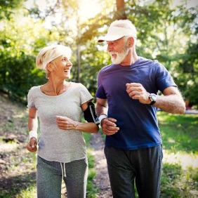 Healthy senior couple jogging outdoors