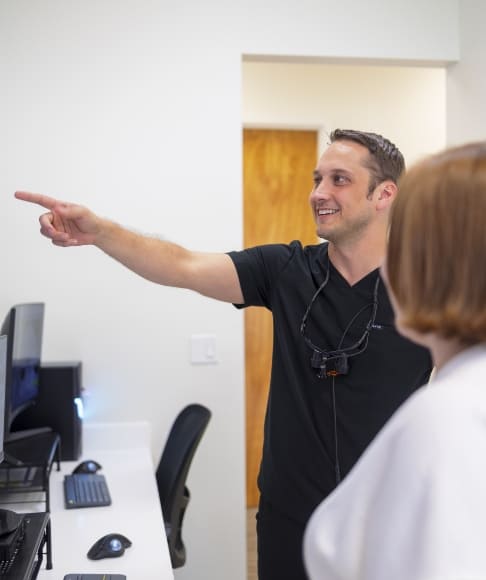 Dentist and lab technician reviewing dental restoration plan