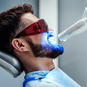 Man undergoing in-office teeth whitening treatment